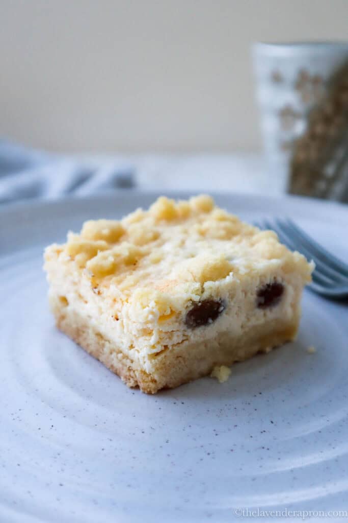 Creamy cottage cheese cake slice served in a beige plate.