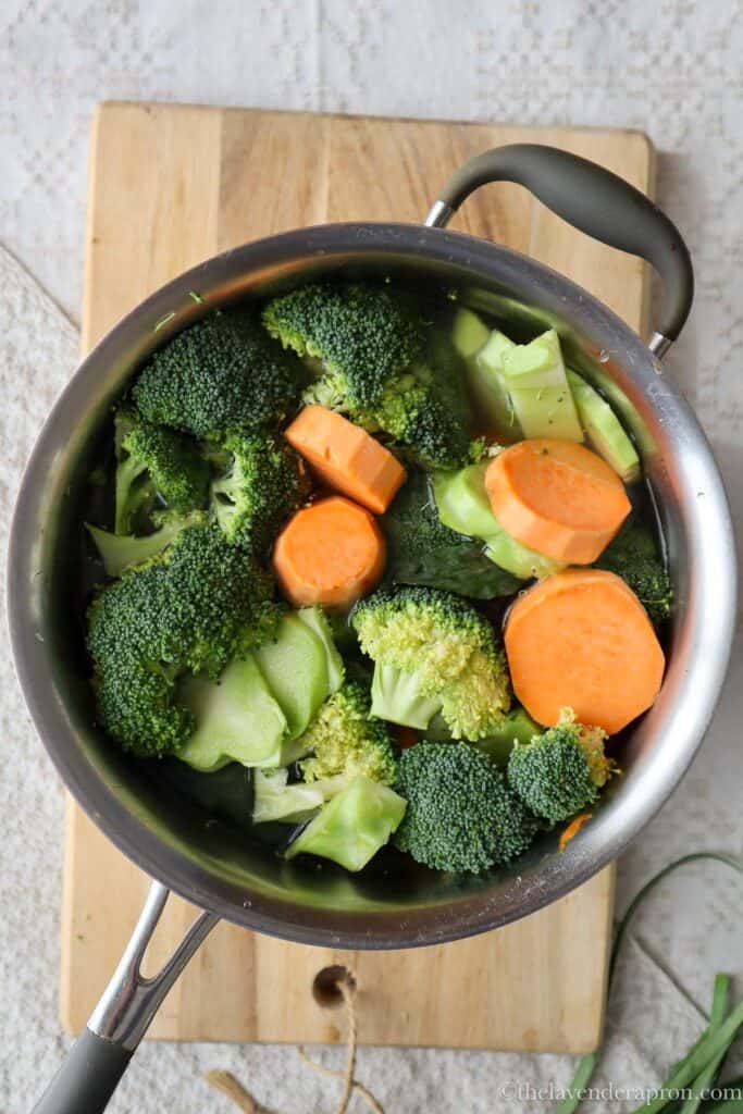 Adding broccoli and sweet potato to the pot.