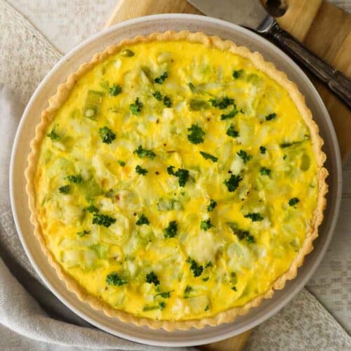 Overhead shot of leek and gruyère quiche with a serving spatula.