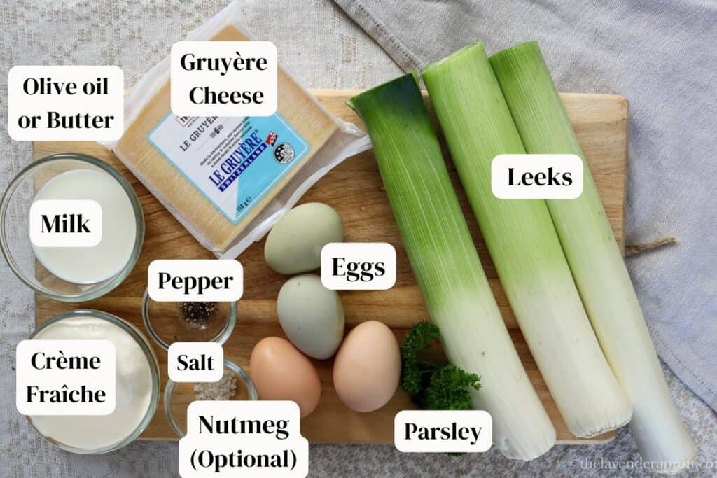 Leek and Gruyère Quiche Recipe Ingredients on a wooden board.