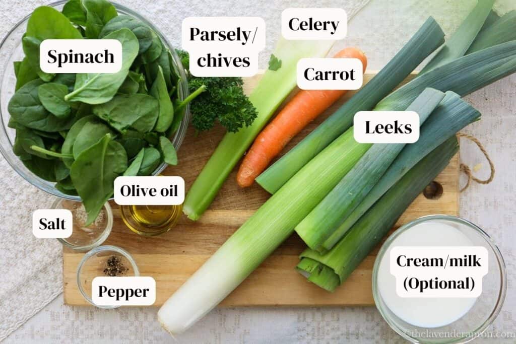 Ingredients to make spinach leek soup placed on cutttig board.