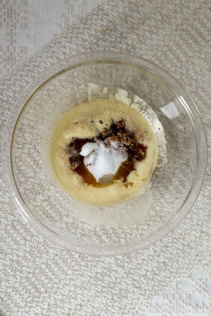 Adding brown and white sugar and orange zest to the melted butter.