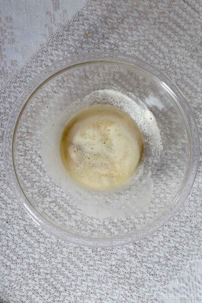 Browned butter and some water poured into heatproof glass bowl.