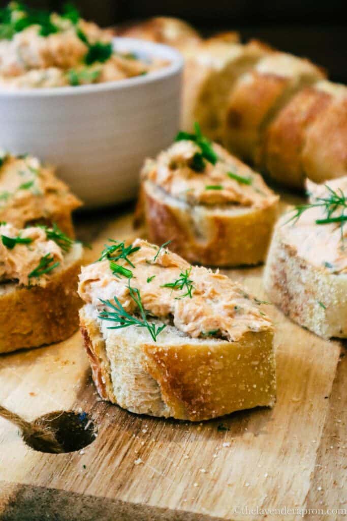 salmon cream cheese spread on baguette toasts with fresh dill.