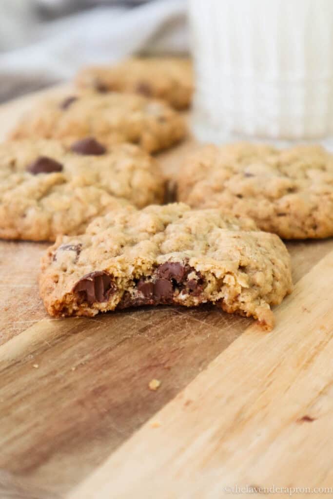 Oatmeal chocolate chip cookie with a bite taken out, showing the chewy center.