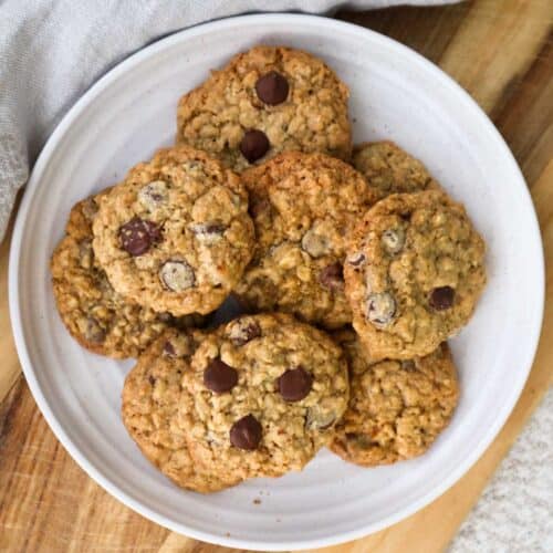 A plate of easy oatmeal chocolate chip cookies with chocolate chips showing on top.