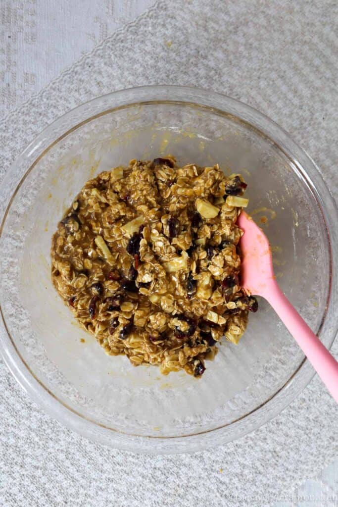 White chocolate chips, cranberries and oats mixed into the cookie dough with a spatula.